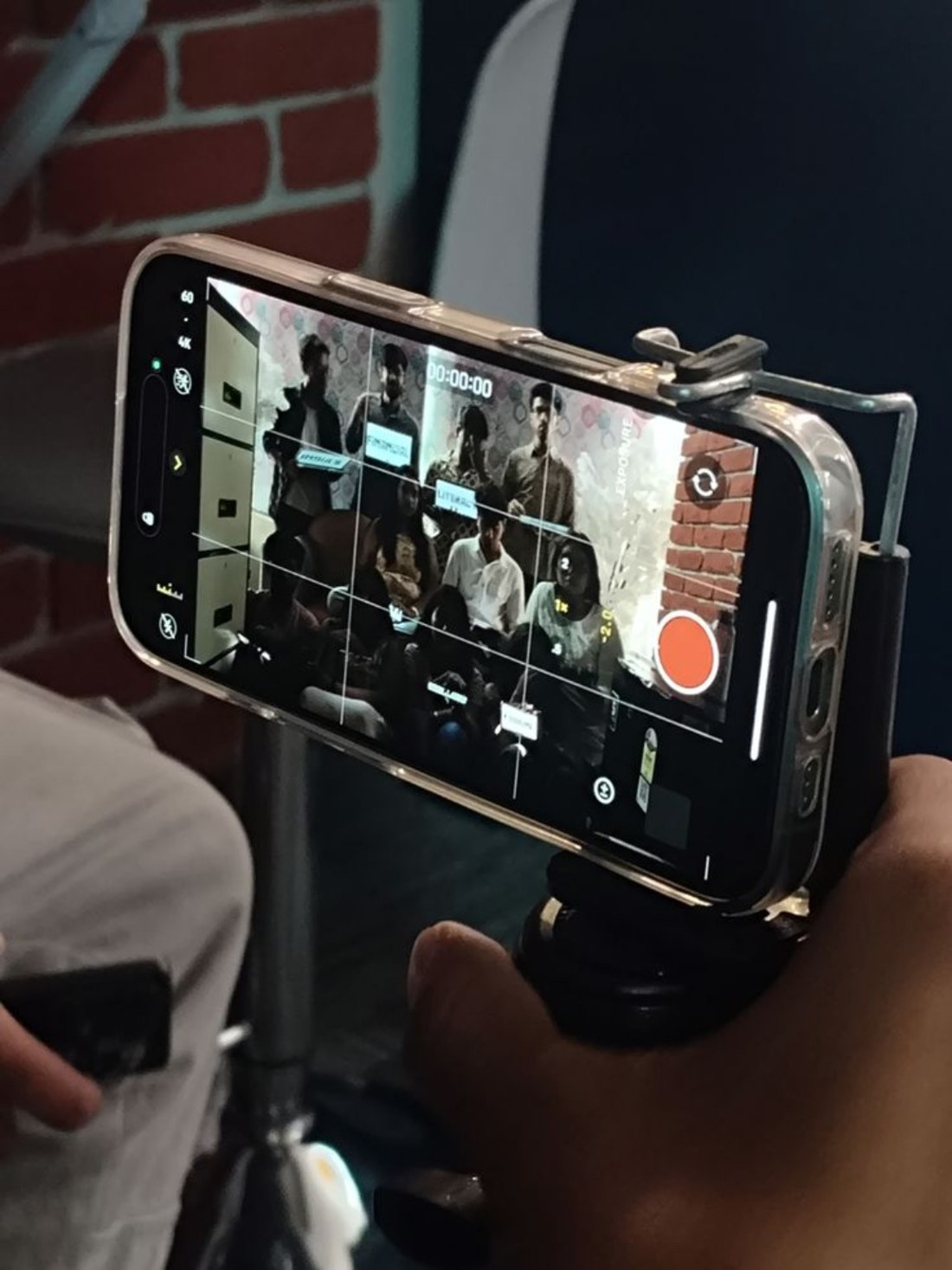 A phone on a filming rig framing people for a shoot